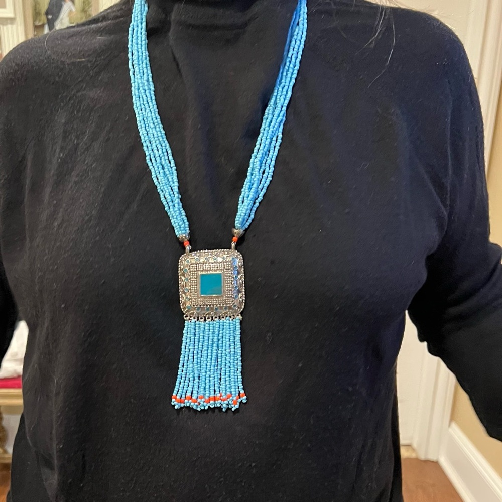 Beautiful Turquoise beaded necklace with silver hanging pendant.